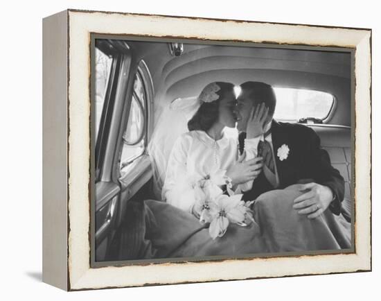 Mr. and Mrs. Thomas Beagan Jr. Kissing in Back of Car after their Wedding Ceremony-Ed Clark-Framed Premier Image Canvas