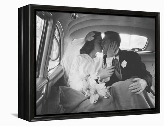 Mr. and Mrs. Thomas Beagan Jr. Kissing in Back of Car after their Wedding Ceremony-Ed Clark-Framed Premier Image Canvas