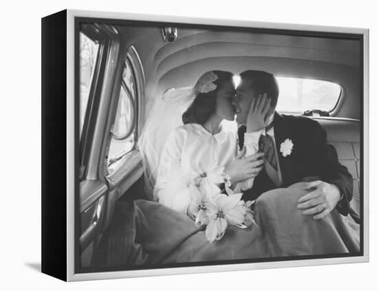 Mr. and Mrs. Thomas Beagan Jr. Kissing in Back of Car after their Wedding Ceremony-Ed Clark-Framed Premier Image Canvas