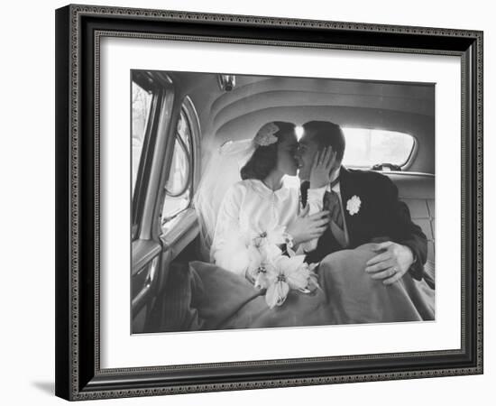 Mr. and Mrs. Thomas Beagan Jr. Kissing in Back of Car after their Wedding Ceremony-Ed Clark-Framed Photographic Print