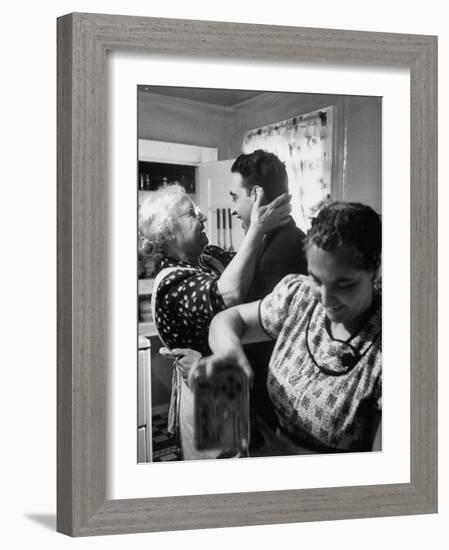 Mrs. Alfonso La Falce Kissing Baby Son at Family Reunion Dinner-Ralph Morse-Framed Photographic Print