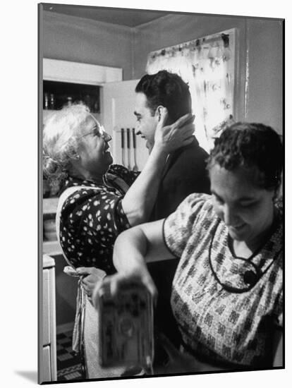 Mrs. Alfonso La Falce Kissing Baby Son at Family Reunion Dinner-Ralph Morse-Mounted Photographic Print