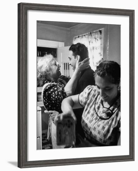 Mrs. Alfonso La Falce Kissing Baby Son at Family Reunion Dinner-Ralph Morse-Framed Photographic Print