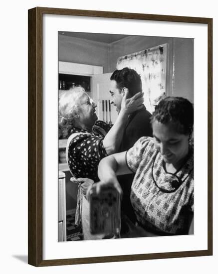Mrs. Alfonso La Falce Kissing Baby Son at Family Reunion Dinner-Ralph Morse-Framed Photographic Print