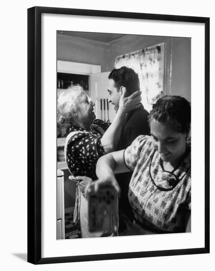 Mrs. Alfonso La Falce Kissing Baby Son at Family Reunion Dinner-Ralph Morse-Framed Photographic Print