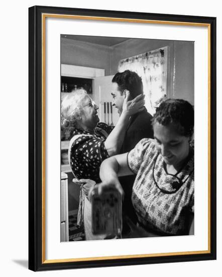 Mrs. Alfonso La Falce Kissing Baby Son at Family Reunion Dinner-Ralph Morse-Framed Photographic Print