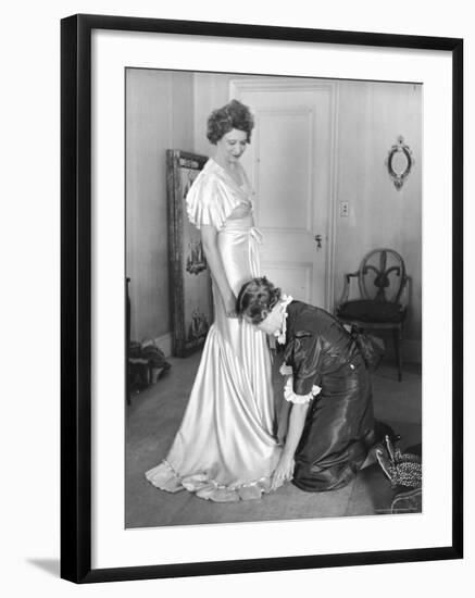 Mrs. Elizabeth Arden Graham Having Her Maid Fix Hem of Evening Gown-Alfred Eisenstaedt-Framed Premium Photographic Print