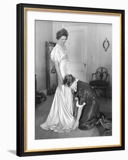 Mrs. Elizabeth Arden Graham Having Her Maid Fix Hem of Evening Gown-Alfred Eisenstaedt-Framed Premium Photographic Print