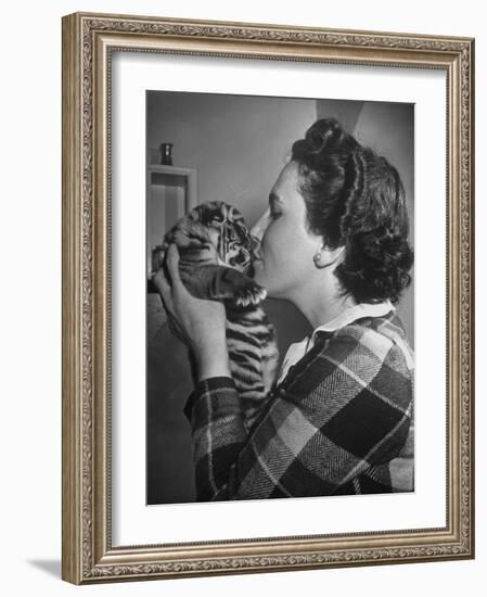 Mrs. Martini, Wife of the Bronx Zoo Lion Keeper, Kissing a Tiger Cub-Alfred Eisenstaedt-Framed Photographic Print