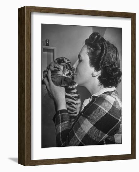 Mrs. Martini, Wife of the Bronx Zoo Lion Keeper, Kissing a Tiger Cub-Alfred Eisenstaedt-Framed Photographic Print