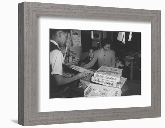 Mrs. Yaeko Nakamura shows her daughters jigsaw puzzles in a store at Manzanar, 1943-Ansel Adams-Framed Photographic Print