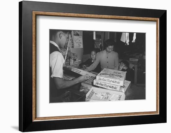 Mrs. Yaeko Nakamura shows her daughters jigsaw puzzles in a store at Manzanar, 1943-Ansel Adams-Framed Photographic Print