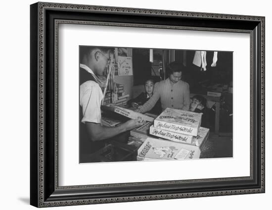 Mrs. Yaeko Nakamura shows her daughters jigsaw puzzles in a store at Manzanar, 1943-Ansel Adams-Framed Photographic Print