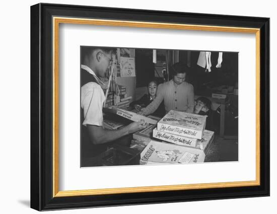 Mrs. Yaeko Nakamura shows her daughters jigsaw puzzles in a store at Manzanar, 1943-Ansel Adams-Framed Photographic Print