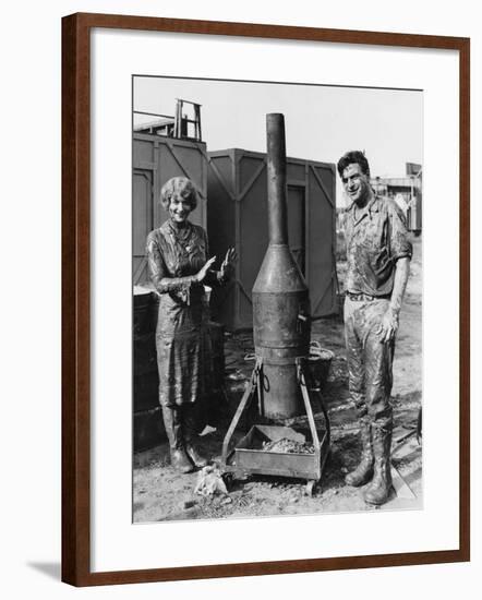 Mud Covered Couple with Portable Stove-null-Framed Photo