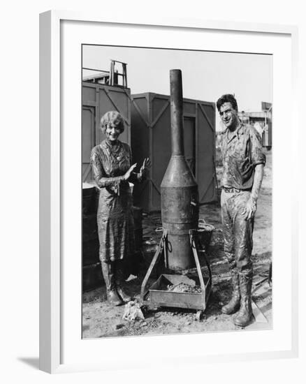 Mud Covered Couple with Portable Stove-null-Framed Photo