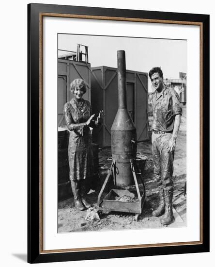 Mud Covered Couple with Portable Stove-null-Framed Photo