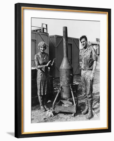 Mud Covered Couple with Portable Stove-null-Framed Photo