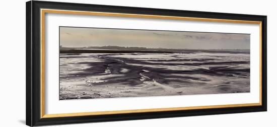 Mud flats of Pagham Harbour nature reserve are softly lit at low tide-Charles Bowman-Framed Photographic Print