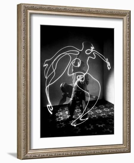 Multiple Exposure of Artist Pablo Picasso Using Flashlight to Make Light Drawing of a Figure-Gjon Mili-Framed Photographic Print