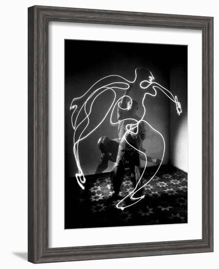 Multiple Exposure of Artist Pablo Picasso Using Flashlight to Make Light Drawing of a Figure-Gjon Mili-Framed Photographic Print