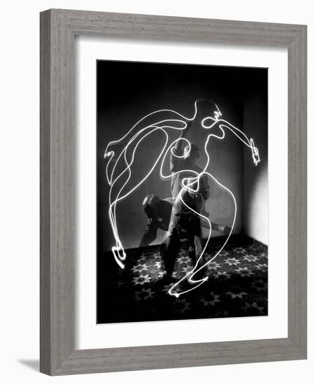 Multiple Exposure of Artist Pablo Picasso Using Flashlight to Make Light Drawing of a Figure-Gjon Mili-Framed Photographic Print