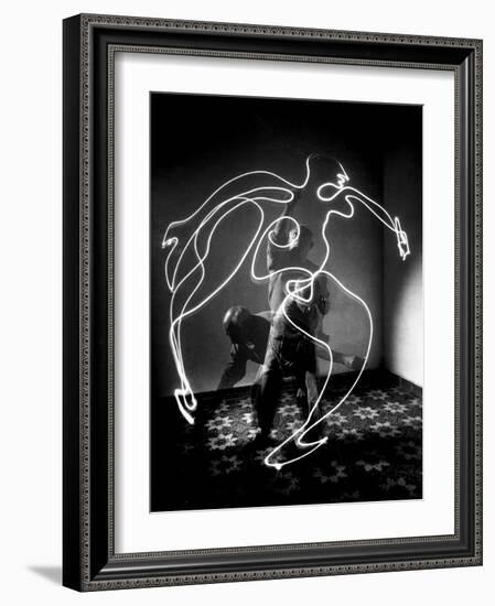 Multiple Exposure of Artist Pablo Picasso Using Flashlight to Make Light Drawing of a Figure-Gjon Mili-Framed Photographic Print