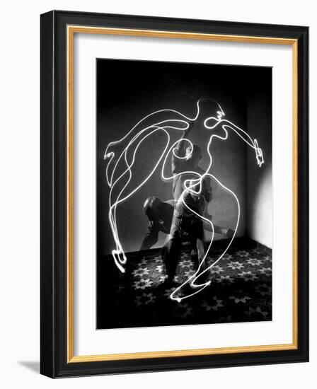 Multiple Exposure of Artist Pablo Picasso Using Flashlight to Make Light Drawing of a Figure-Gjon Mili-Framed Photographic Print