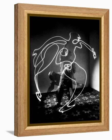 Multiple Exposure of Artist Pablo Picasso Using Flashlight to Make Light Drawing of a Figure-Gjon Mili-Framed Premier Image Canvas