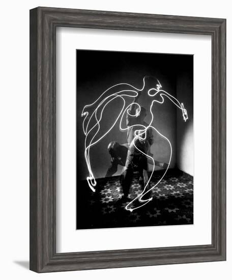 Multiple Exposure of Artist Pablo Picasso Using Flashlight to Make Light Drawing of a Figure-Gjon Mili-Framed Photographic Print