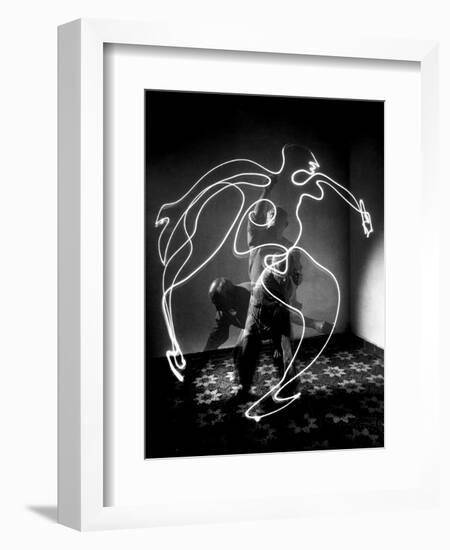 Multiple Exposure of Artist Pablo Picasso Using Flashlight to Make Light Drawing of a Figure-Gjon Mili-Framed Photographic Print