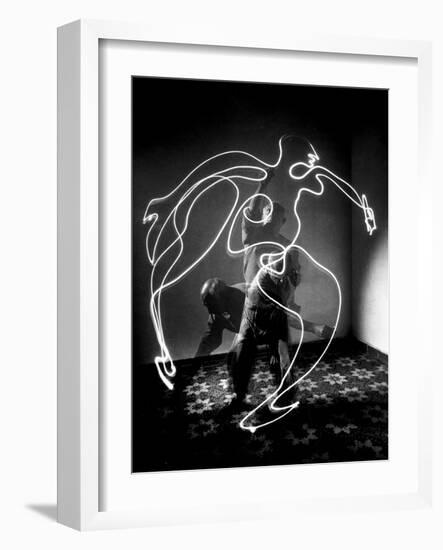 Multiple Exposure of Artist Pablo Picasso Using Flashlight to Make Light Drawing of a Figure-Gjon Mili-Framed Premium Photographic Print