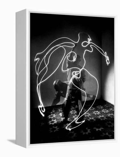 Multiple Exposure of Artist Pablo Picasso Using Flashlight to Make Light Drawing of a Figure-Gjon Mili-Framed Premier Image Canvas