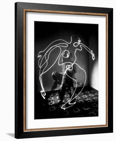 Multiple Exposure of Artist Pablo Picasso Using Flashlight to Make Light Drawing of a Figure-Gjon Mili-Framed Giclee Print