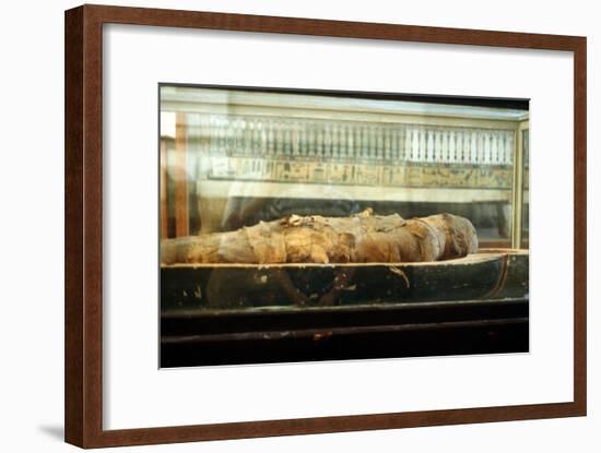 Mummy wrapped in bandages and lying on the base of a coffin, Ancient Egyptian. Artist: Unknown-Unknown-Framed Giclee Print