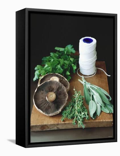 Mushrooms, Fresh Herbs & Kitchen String on Chopping Board-Michael Paul-Framed Premier Image Canvas