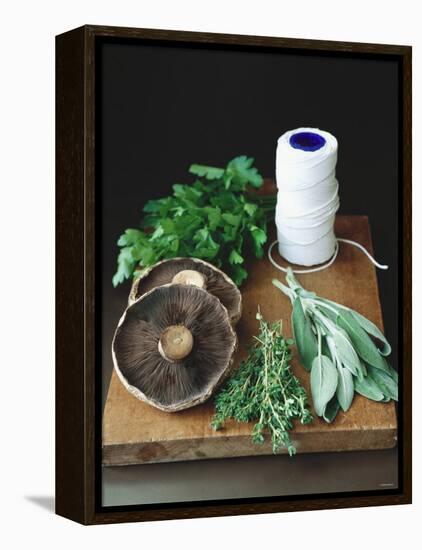 Mushrooms, Fresh Herbs & Kitchen String on Chopping Board-Michael Paul-Framed Premier Image Canvas