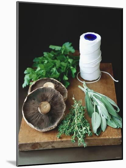 Mushrooms, Fresh Herbs & Kitchen String on Chopping Board-Michael Paul-Mounted Photographic Print