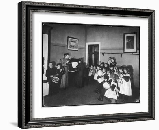 Music Lesson at a German School. One Teacher Plays the Piano-null-Framed Art Print