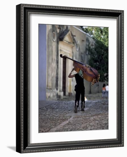 Musician Carrying Double Bass Along Cobbled Street to Plaza Mayor, Trinidad, Cuba-Lee Frost-Framed Photographic Print