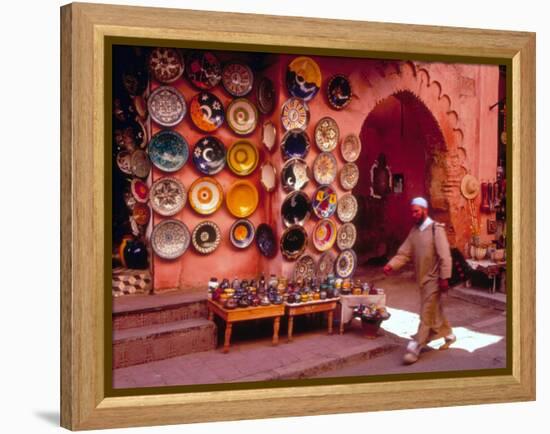 Muslim Man Walks by Wall of Moroccan Pottery, Marrakech, Morocco-John & Lisa Merrill-Framed Premier Image Canvas