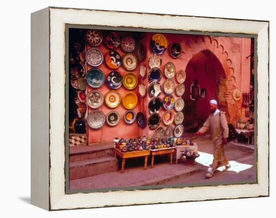 Muslim Man Walks by Wall of Moroccan Pottery, Marrakech, Morocco-John & Lisa Merrill-Framed Premier Image Canvas