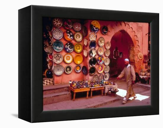 Muslim Man Walks by Wall of Moroccan Pottery, Marrakech, Morocco-John & Lisa Merrill-Framed Premier Image Canvas