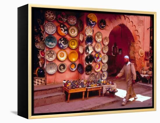 Muslim Man Walks by Wall of Moroccan Pottery, Marrakech, Morocco-John & Lisa Merrill-Framed Premier Image Canvas