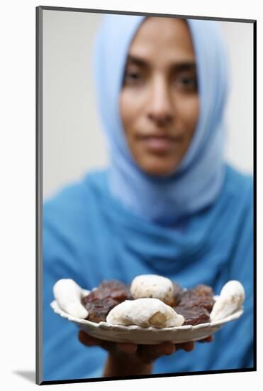 Muslim woman offering Ramadan pastries-Godong-Mounted Photographic Print