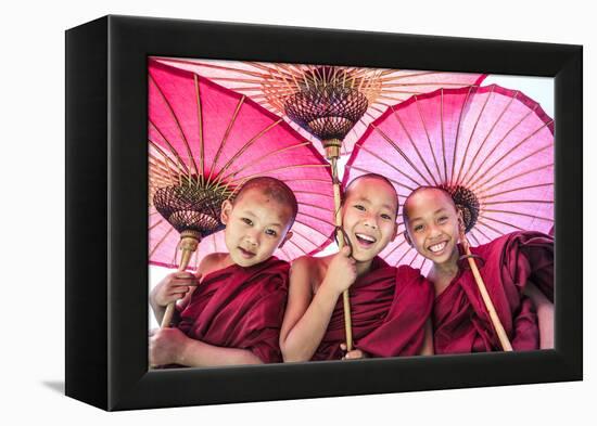 Myanmar, Mandalay Division, Bagan. Portrait of Three Novice Monks under Red Umbrellas (Mr)-Matteo Colombo-Framed Premier Image Canvas