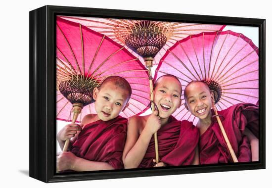 Myanmar, Mandalay Division, Bagan. Portrait of Three Novice Monks under Red Umbrellas (Mr)-Matteo Colombo-Framed Premier Image Canvas