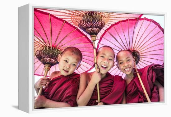 Myanmar, Mandalay Division, Bagan. Portrait of Three Novice Monks under Red Umbrellas (Mr)-Matteo Colombo-Framed Premier Image Canvas