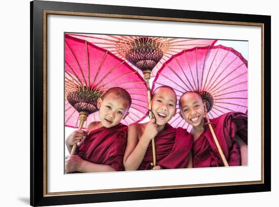 Myanmar, Mandalay Division, Bagan. Portrait of Three Novice Monks under Red Umbrellas (Mr)-Matteo Colombo-Framed Photographic Print