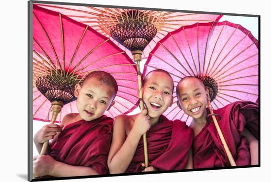 Myanmar, Mandalay Division, Bagan. Portrait of Three Novice Monks under Red Umbrellas (Mr)-Matteo Colombo-Mounted Photographic Print